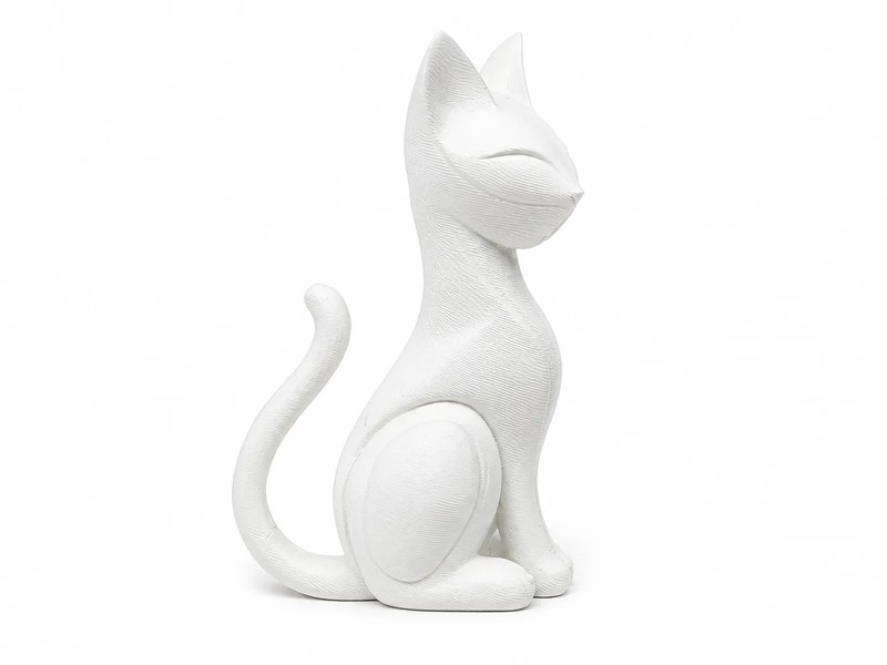 White sculpted sitting cat figurine with a curled tail and closed eyes