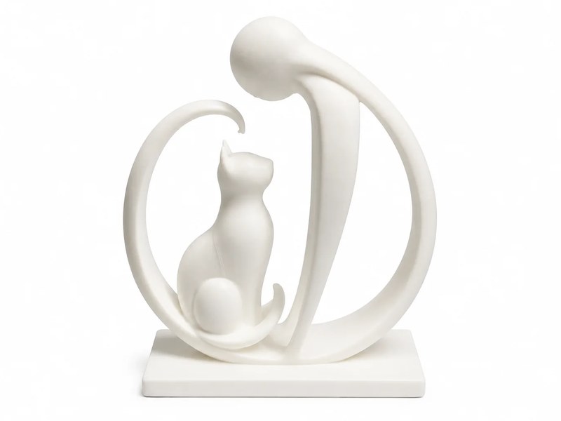 White handmade 3D printed sculpture of a sitting cat framed by a curved figure leaning over it